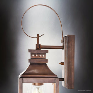The UFS1000 Calderdale Collection Outdoor Wall Sconce by Urban Ambiance features genuine copper with a dark-patina finish, a rectangular base, square body, and curved loop handle for timeless charm in any outdoor setting.