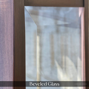 Close-up of beveled glass and wood frame reflecting outdoors, with the soft glow of Urban Ambiance’s UFS1002 Transitional Outdoor Wall Sconce, 28.5