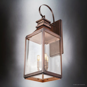 The Urban Ambiance UFS1002 Calderdale Collection Transitional Outdoor Wall Sconce features genuine copper with a dark-patina finish, showcasing a rectangular glass enclosure and two visible bulbs for classic style.