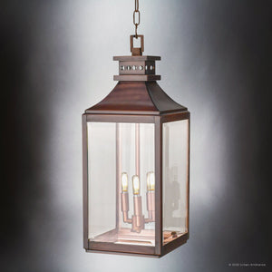 The Urban Ambiance UFS1004 Calderdale Collection pendant light features a 26.5''H x 9.5''W rectangular genuine copper frame in dark-patina, classic glass panels, and three candle-style bulbs for transitional outdoor elegance.