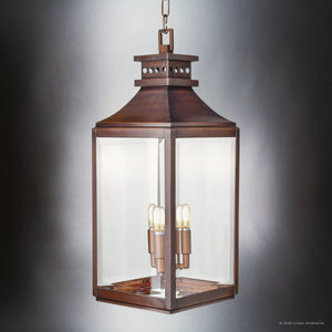 The Urban Ambiance UFS1004 Calderdale Collection outdoor pendant light features a genuine copper, dark-patina rectangular frame with clear glass panels, suspended by a chain and holds four exposed bulbs. Size: 26.5''H x 9.5''W.