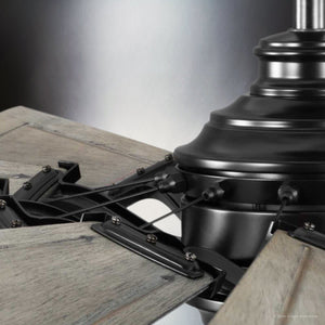 Close-up of the Urban Ambiance UHP9478 Tuscan Indoor Ceiling Fan with a matte black finish from the Saybrook Collection, featuring wooden blades and an antique nickel body in a windmill-inspired design, elegantly showcasing its hardware and connection points.