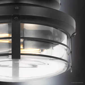 Close-up of the Urban Ambiance Tuscan Ceiling Fan from the Saybrook Collection featuring a matte black finish with a modern design and clear glass enclosure, showcasing lit bulbs for a blend of contemporary style and timeless elegance.