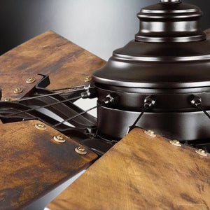 This close-up showcases the exquisitely detailed metal base and uniquely crafted blades of the UHP9480 Tuscan Indoor Ceiling Fan, with an architectural bronze finish, part of the Urban Ambiance Saybrook Collection.