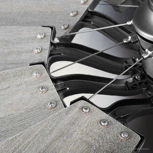 Close-up of the Urban Ambiance UHP9481 Tuscan Indoor Ceiling Fan from the Saybrook Collection, featuring five wooden blades in a rustic design with antique nickel finish and black metal brackets. The angle showcases its unique industrial style.