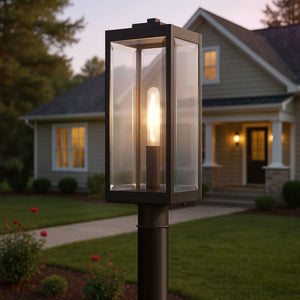 The UQL1353 Modern Farmhouse Outdoor Post/Pier Light from Urban Ambiance’s Quincy Collection features clear glass panels and an elegant estate bronze finish, standing 20.5″ high by 7″ wide. This stylish fixture is designed to illuminate your home’s entryway at dusk, providing a warm welcome amid beautifully landscaped surroundings.