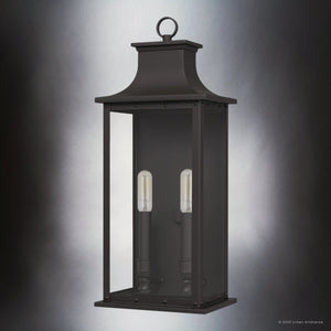 The UQL1720 Classic Outdoor Wall Sconce by Urban Ambiance features an old bronze finish, clear beveled glass, and two exposed vertical bulbs in a rectangular design (19.50''H x 8.25''W x 6.50''D), from the Halle Collection with marine-grade construction.