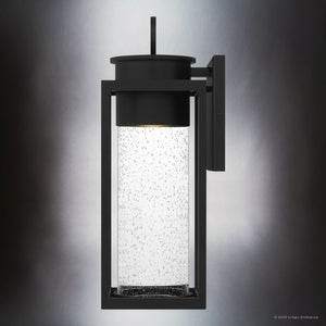 The Urban Ambiance UQL1780 Classic Outdoor Wall Sconce from the Nicosia Collection features marine-grade matte black aluminum, a rectangular frame, and clear seeded glass; measures 18.75