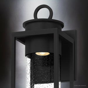 Close-up of the Urban Ambiance UQL1780 Classic Outdoor Wall Sconce from the Nicosia Collection, featuring marine-grade matte black aluminum and clear seeded glass with a visible bulb. Measures 18.75