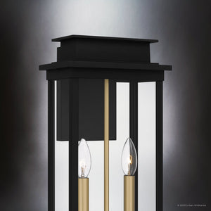 The Urban Ambiance UQL1821 Selby Collection outdoor wall sconce features a matte black finish and marine-grade construction, measuring 18.75''H x 8.75''W x 6.00''D, shown shining against a gray gradient background.