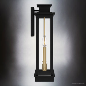 The Urban Ambiance UQL1821 Selby Collection outdoor wall sconce features a matte black finish, visible bulb, and clear glass enclosure for modern style on any gray wall. Marine-grade construction ensures durability. 18.75