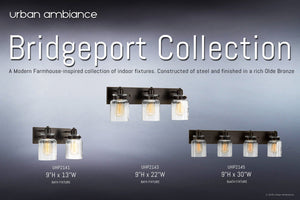 Urban Ambiance’s UHP2143 Modern Farmhouse Industrial Bath Fixture from the Bridgeport Collection, measuring 8-5/8 inches high by 21-5/8 inches wide and finished in Olde Bronze, showcases three clear glass shades reminiscent of jar lighting with exposed bulbs for an authentic vintage bathroom look, displayed against a gray gradient background.