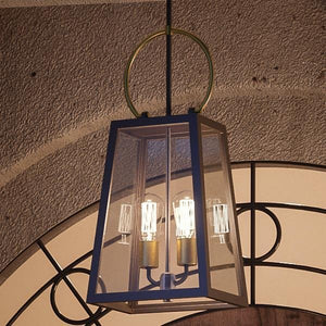 A unique UHP1003 Modern Farmhouse outdoor pendant light, 26.875"H x 11.25"W, in a gorgeous Olde Bronze finish from Urban Ambiance hanging from a doorway