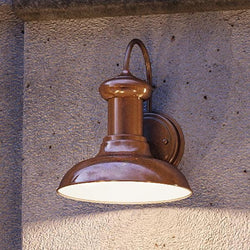 An UHP1020 Industrial Chic outdoor lamp on a concrete wall.