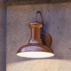 An UHP1020 Industrial Chic outdoor lamp on a concrete wall.
