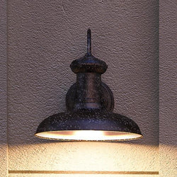 An UHP1024 Industrial Chic outdoor wall lighting fixture on the side of a building, designed by Urban Ambiance.