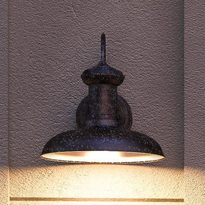 An UHP1024 Industrial Chic outdoor wall lighting fixture on the side of a building, designed by Urban Ambiance.