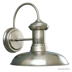 The UHP1025 Luxe Industrial Chic Outdoor Wall Light from the Palermo Collection by Urban Ambiance features a wide, dome-shaped shade and gracefully curved arm in an aged nickel finish, shown wall-mounted against a white background. The fixture measures 10.75″ high by 10″ wide.