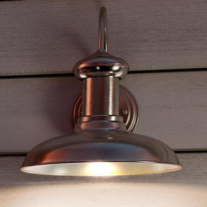 A unique UHP1030 Industrial Chic Outdoor Wall Light on a wooden wall.