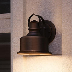 A beautiful UHP1042 Industrial Chic Outdoor Wall Light by Urban Ambiance, on the side of a house.