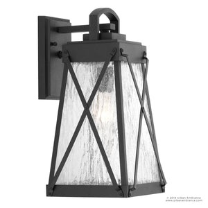 The Urban Ambiance UHP1053 English Country Outdoor Wall Light from the Saint Paul Collection features a midnight black finish, clear textured glass panels, and an X-pattern design on a rectangular backplate. Measuring 15-3/4 inches high by 8-3/8 inches wide, this rustic lantern brings English-inspired charm to your exterior décor.