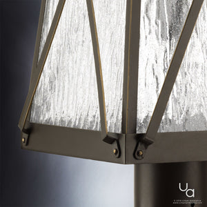 A luxury lighting fixture, the Urban Ambiance UHP1056 English Tudor Outdoor Post/Pier Light, adds a unique touch to outdoor spaces with its Olde Bronze finish and glass shade.