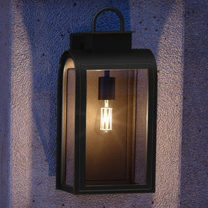 A beautiful UHP1102 Art Deco Outdoor Wall Light with a gorgeous Oil Rubbed Bronze Finish, part of the Chesterfield Collection by Urban Ambiance, illuminating a concrete wall.