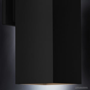 A close-up of the Urban Ambiance UHP1112 Minimalist Outdoor Wall Light from the Madrid Collection, featuring a sleek rectangular design in a midnight black finish, crafted from die-cast aluminum, with light softly glowing downward against a dark background.