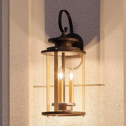 A unique lighting fixture, the Urban Ambiance UHP1120 Rustic Outdoor Wall Light features a luxury Olde Bronze finish and 19.25"H x 8"W dimensions, with two candles