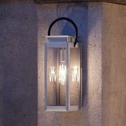 A luxury UHP1132 Modern Farmhouse Outdoor Wall Light hanging on a wall by Urban Ambiance.