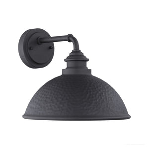 The Urban Ambiance UHP1177 Hammered Outdoor Wall Light from the Firenze Collection features a round, hammered metal shade and angled arm mounted on a circular backplate, boasting an industrial-inspired design in a striking midnight black finish. Measuring 10-3/8″ x 12″, it brings modern style to any space.