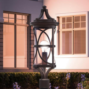 A luxurious outdoor lamp from the Brussels Collection, featuring a beautiful Olde Bronze finish, enhances the ambiance in front of a house.