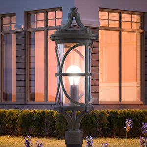 A beautiful Urban Ambiance UHP1181 Rustic Outdoor Post Lamp, 26-1/2" x 9", Aged Pewter Finish, Brussels Collection in front of a house at