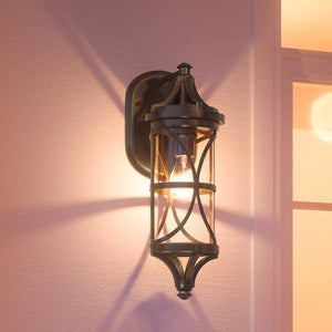 A beautiful Urban Ambiance UHP1186 Rustic Outdoor Wall Light with an Olde Bronze Finish, showcased on a wall in a room.