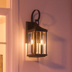 An Urban Ambiance UHP1193 Colonial Outdoor Wall Light, 21-3/4" x 7", Olde Bronze Finish, Calderdale Collection with two lights on it.