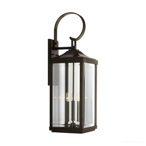 Elevate your entryway with the UHP1194 Colonial Outdoor Wall Light from Urban Ambiance’s Calderdale Collection, featuring an Olde Bronze finish, beveled clear glass panels, and three candle-like bulbs within a classic 30-5/8″ x 9-1/2″ design—timeless Colonial charm accented by a graceful curved top handle and sturdy wall bracket.