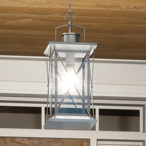 A beautiful Colonial Outdoor Pendant Light hanging from a wooden porch.