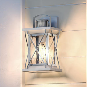 A gorgeous Urban Ambiance UHP1222 Colonial Outdoor Wall Light, 13"H x 6.5"W, Stainless Steel Finish, Longmont Collection on the side of a house.