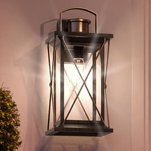 A luxury Colonial Outdoor Wall Light, 19"H x 9.125"W, Olde Bronze Finish, Longmont Collection by Urban Ambiance with a unique twist - a plant on it