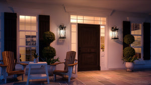An image of a unique and beautiful Colonial Outdoor Wall Light from the Longmont Collection porch with chairs and a door.