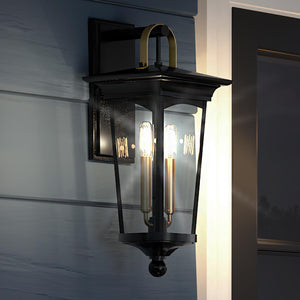 A unique UHP1263 Cosmopolitan Outdoor Wall Light, 22"H x 9"W, with a midnight black finish from the Asheville Collection by Urban Ambiance on the side of a house