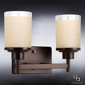 The Urban Ambiance UHP2011 Contemporary Bathroom Vanity Light from the Cupertino Collection features a modern two-light design with frosted cylindrical glass shades and an olde bronze metal base, elegantly mounted on a square backplate for a stylish update to contemporary vintage bath lighting. Measuring 9.5 inches high by 13 inches wide, this versatile fixture is perfect for enhancing any bathroom décor.