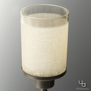 A close-up of the Urban Ambiance UHP2011 Contemporary Bathroom Vanity Light from the Cupertino Collection, featuring a cylindrical frosted glass shade with a subtle textured pattern and a metal base in an Olde Bronze finish, set against a plain gray background.
