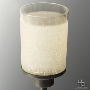 The UHP2015 Contemporary Bathroom Vanity Light from the Cupertino Collection by Urban Ambiance features a cylindrical frosted glass shade and a metallic base in an Olde Bronze finish. Illuminated, it casts a soft glow while its contemporary vintage design brings distinctive character to the space. The Urban Ambiance logo appears in the lower right corner.
