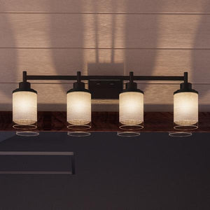 A contemporary ceiling light fixture from the Urban Ambiance Cupertino Collection, featuring five illuminated cylindrical frosted glass shades and a dark metal base with an Olde Bronze finish, is mounted against a wood-paneled ceiling. The model shown is the UHP2015 Bathroom Vanity Light, measuring 9.4375 inches high by 31 inches wide.