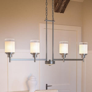 The Urban Ambiance UHP2019 Contemporary Chandelier from the Cupertino Collection features five cylindrical frosted glass shades and a sleek brushed nickel finish. Measuring 20 inches high by 34.167 inches wide and suspended by two chains, this chandelier adds a modern touch to any neutral-toned room.