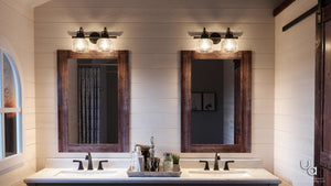 A gorgeous bathroom with two UHP2041 Industrial Chic Bath Fixtures in a Fashion Bronze Finish from the Harlow Collection by Urban Ambiance, and two mirrors.