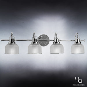 The UHP2046 Luxe Industrial Bath Fixture by Urban Ambiance features four clear ribbed prismatic glass shades and a polished chrome finish, mounted on a circular wall plate from the Harlow Collection, and is elegantly displayed against a gray gradient background for an industrial bath light aesthetic.