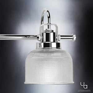 Close-up of the UHP2046 Luxe Industrial Bath Fixture from the Harlow Collection by Urban Ambiance, featuring a polished chrome finish and prismatic glass shade against a gradient gray background, highlighting its refined industrial design.