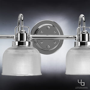 Close-up of the Urban Ambiance UHP2046 Luxe Industrial Bath Fixture from the Harlow Collection, featuring a polished chrome finish and two frosted glass shades, wall-mounted against a dark gradient background.